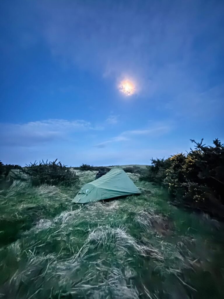 OEX Phoxx 1 V2 tent under full moon in grassy clearing