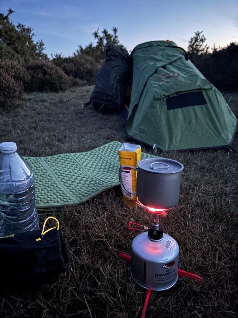 Heating water in a SilverAnt cup for a dehydrated meal inside an OEX Phoxx 1V2 tent during a winter wild camping trip in the UK