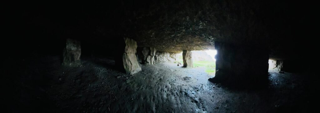 Interior of Winspit Quarry showing support columns with daylight streaming through the entrance