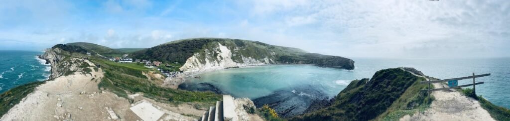 Panoramic view from Lulworth Cove showing the bay on one side and the Dorset coast opening out to the English Channel on the other