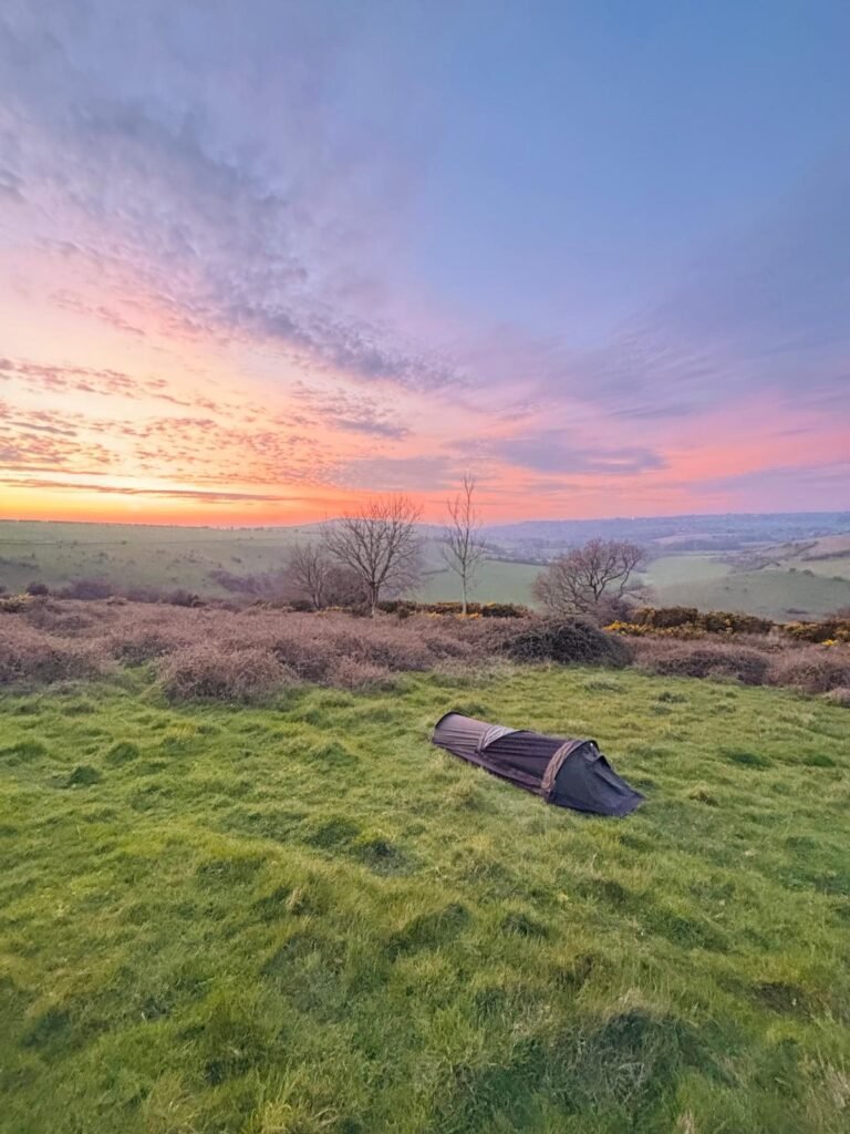 Nortent Skjul bivvi set up on Melbury Down at sunset with bramble cover