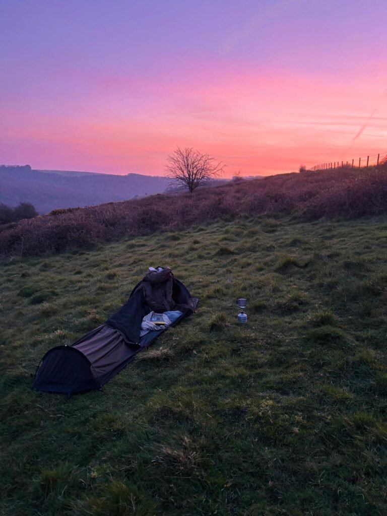 Nortent Skjul bivvi at dawn with pink and purple sky over hills