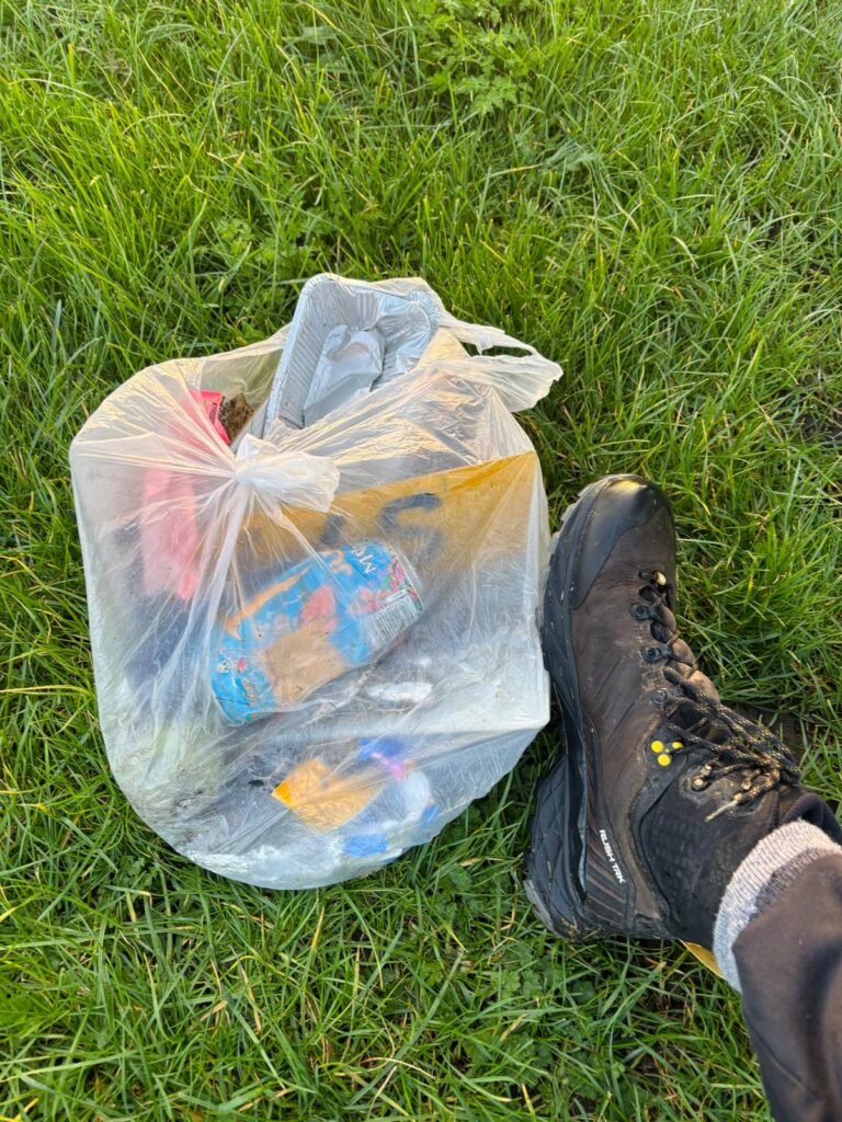 bag of litter collected during wild camping with scarpa boot for scale