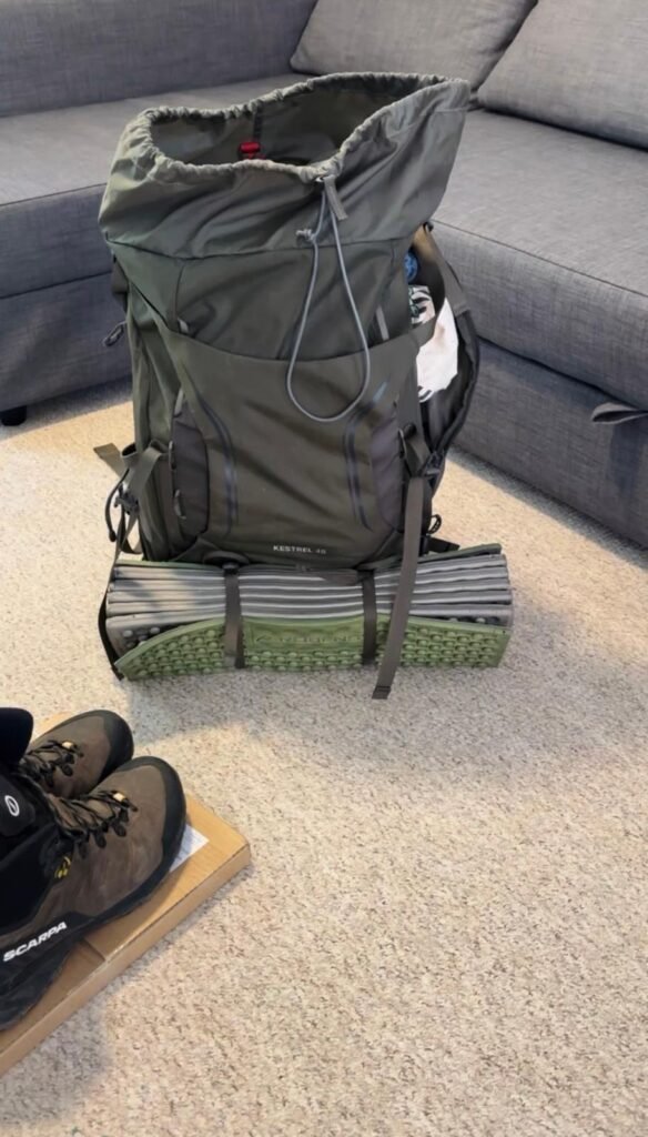 Wild camping backpack and walking boots prepared for a one night trip