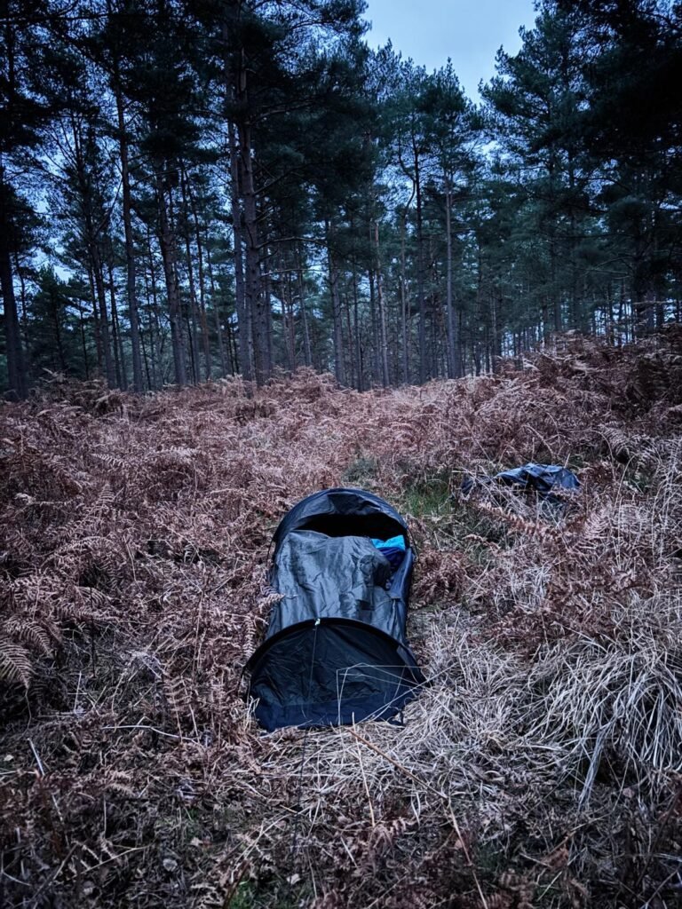 Nortent Skjul bivvi covered in winter moisture after a sub-zero night in a pine forest