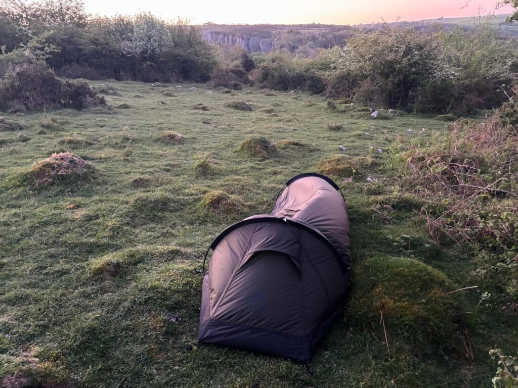 Nortent Skjul pitched above Cheddar Gorge at dawn beside hawthorn bushes for shelter from the wind.