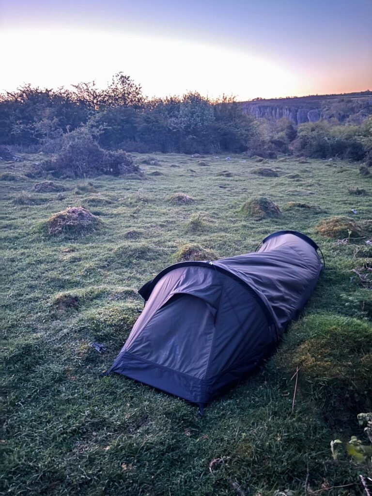 Nortent Skjul pitched above Cheddar Gorge at dawn beside hawthorn bushes for shelter from the wind.