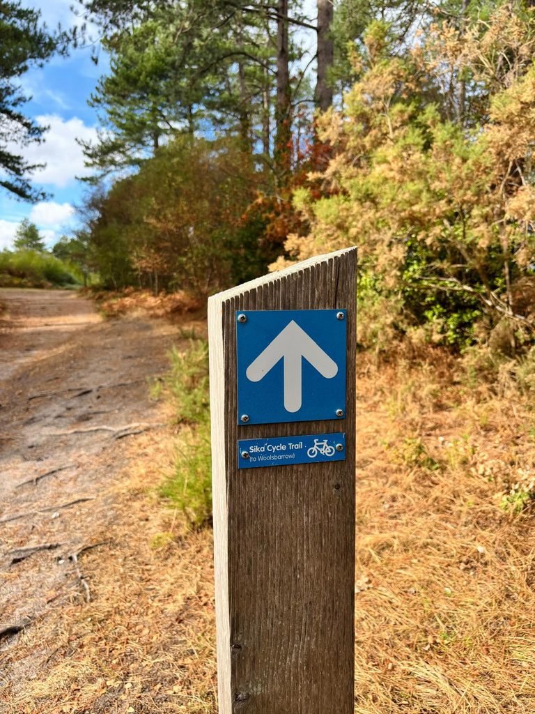 Sika Trail sign pointing towards Woolsbarrow through Wareham Forest