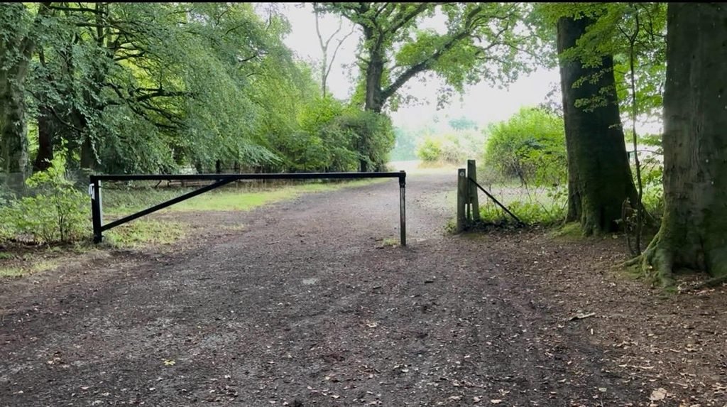 Metal vehicle barrier across the entrance to the Roman Road in Grovely Wood