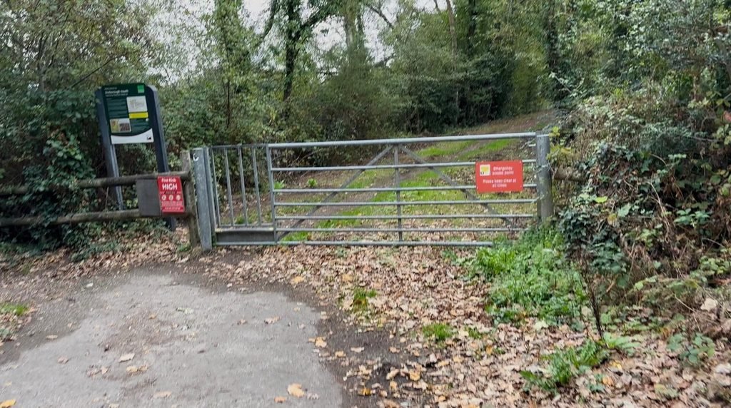 Metal entrance gate from the road onto the tree-lined path to Stoborough Heath